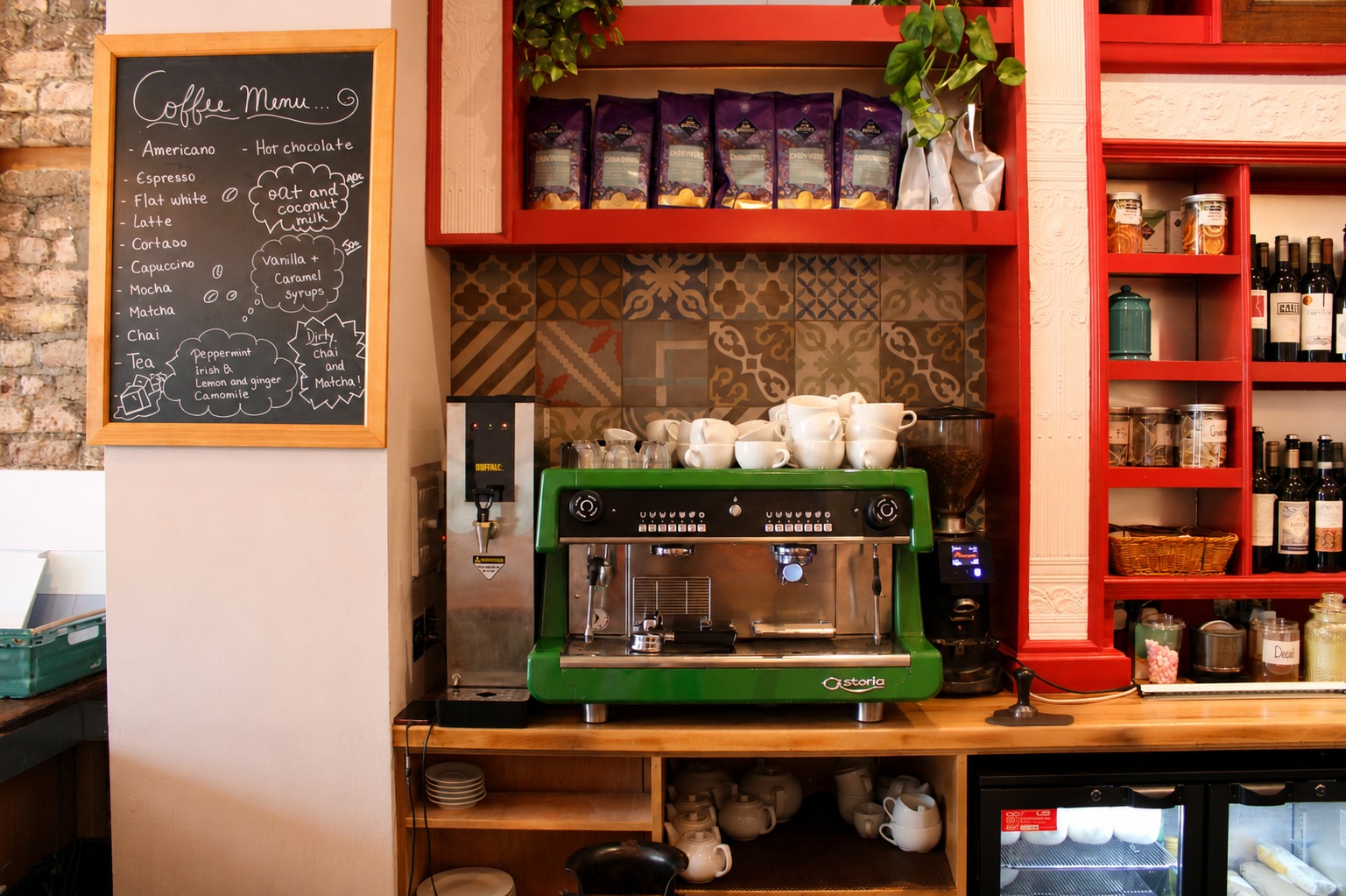 The green Astoria espresso machine and coffee menu board at Quinnín